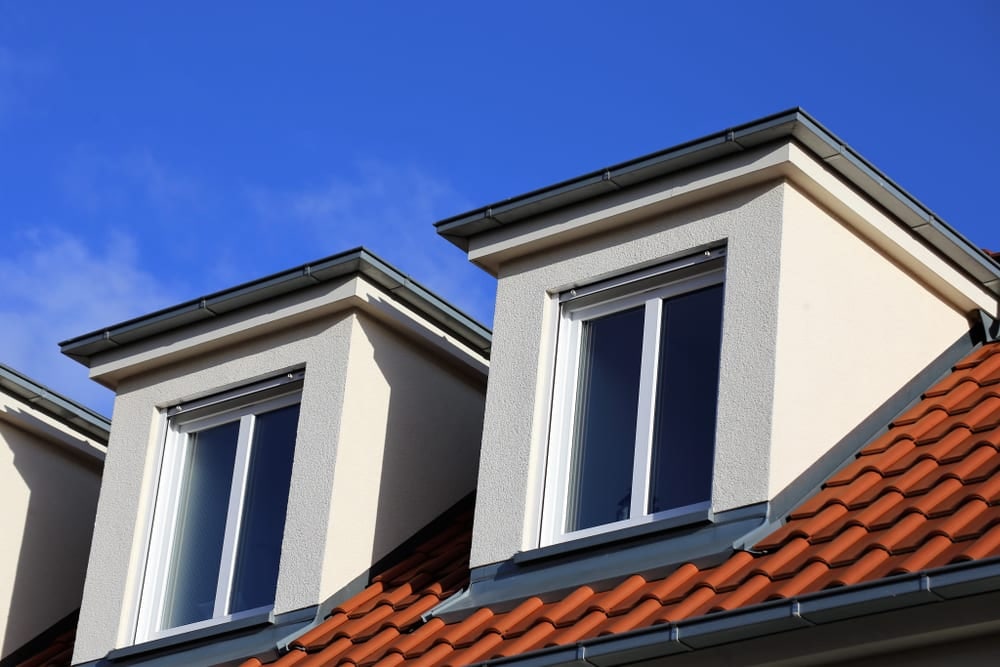 Twin dormer windows projecting from the tiled roof of an Oxford home
