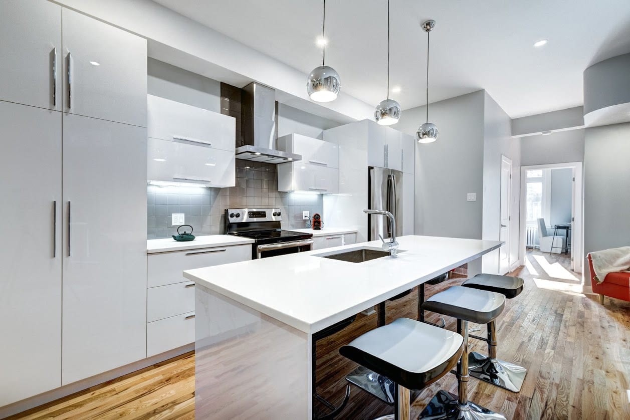 Open-plan fitted kitchen with island seating and integrated appliances in Oxford