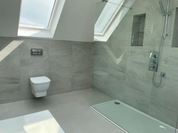 Loft ensuite with a rooflight above a walk-in shower
