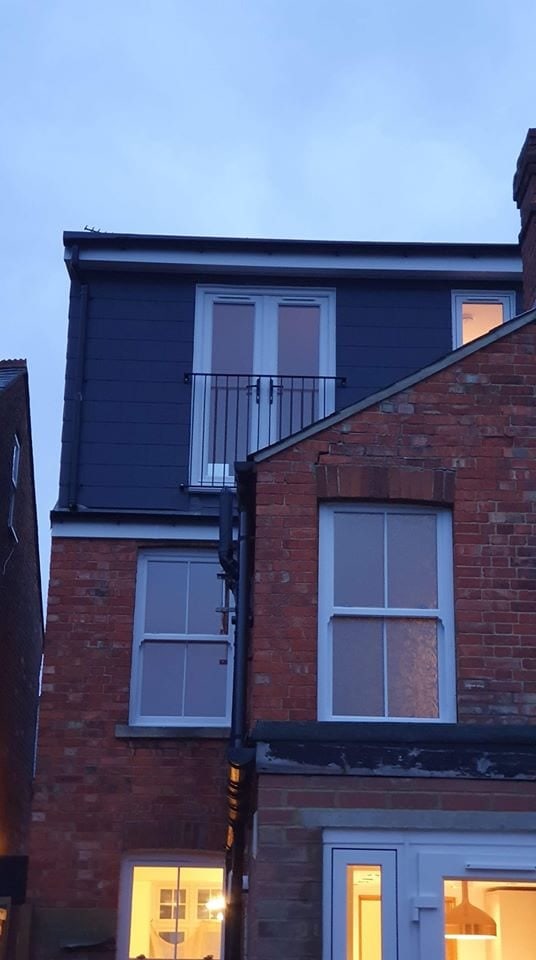 Mansard loft conversion with a Juliet balcony on a red-brick Oxford house
