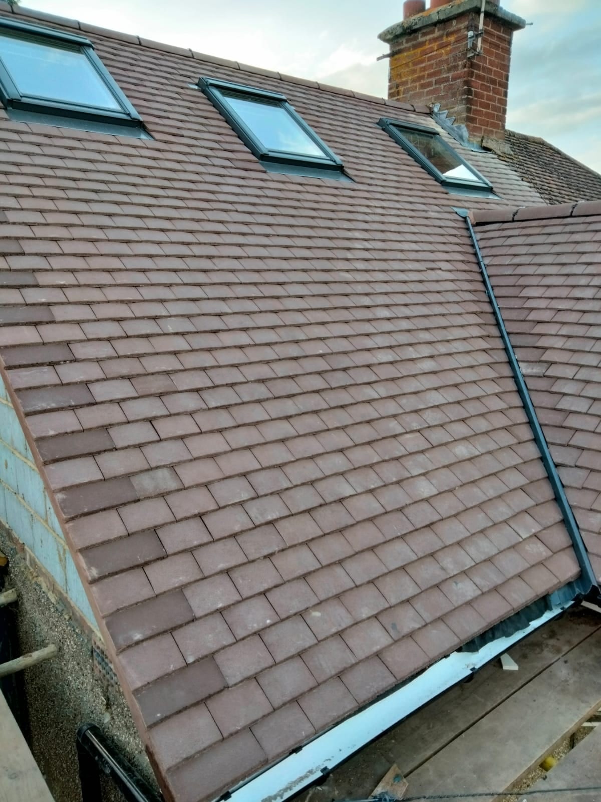 Three Velux roof windows installed in a clay-tiled Oxford roof